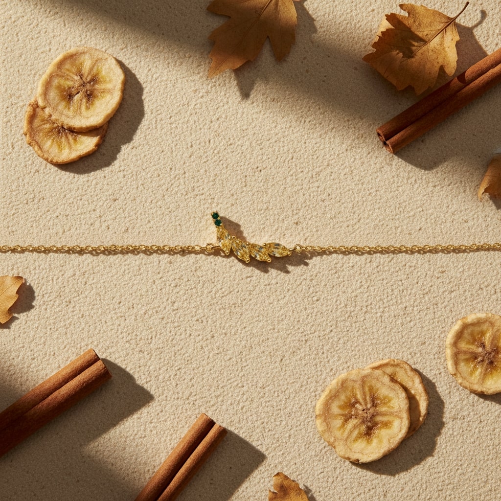 Gold bracelet on a textured beige surface with dried fruit and cinnamon sticks.